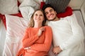 Happy couple lying on bed together laughing Royalty Free Stock Photo