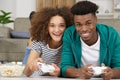 Happy couple lying on floor while playing video-games Royalty Free Stock Photo