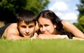 Happy couple lying on grass. Royalty Free Stock Photo