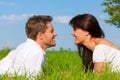 Happy couple lying on a meadow Royalty Free Stock Photo