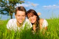 Happy couple lying on a meadow Royalty Free Stock Photo