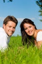 Happy couple lying on a meadow Royalty Free Stock Photo