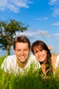 Happy couple lying on a meadow Royalty Free Stock Photo