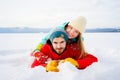 Happy couple lying in snow