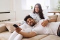 Happy couple lying on sofa together and relaxing at home Royalty Free Stock Photo