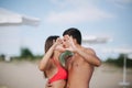 Happy couple make a heart. Woman and man on the beach. They kiss Royalty Free Stock Photo