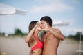 Happy couple make a heart. Woman and man on the beach. They kiss Royalty Free Stock Photo