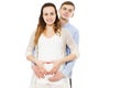 Happy couple making a heart shape on the pregnant belly with their hands. Concept of pregnancy, expecting a baby, love, care Royalty Free Stock Photo