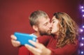 Happy couple making a selfie with mobile smartphone app - Young lovers having fun taking selfie with phone camera Royalty Free Stock Photo