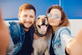 Happy couple making selfie photo with dog Labrador Retriever smiling. Concept young family Royalty Free Stock Photo