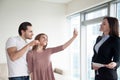 Happy couple making selfie on smartphone showing keys of apartme