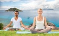 Happy couple making yoga exercises outdoors Royalty Free Stock Photo