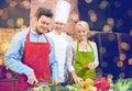 Happy couple and male chef cook cooking in kitchen Royalty Free Stock Photo