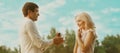 Happy couple, man proposing ring to his woman outdoors, wedding concept Royalty Free Stock Photo