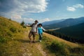 Happy couple man and woman having fun on their hiking trip, the mountain trail. Carpathians mountains, hiker couple enjoying Royalty Free Stock Photo