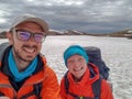 Happy couple man and woman hiking together in mountains with big heavy backpacks. Travel adventure wanderlust active lifestyle Royalty Free Stock Photo