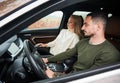 Happy couple man and woman traveling in car