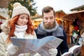 Happy couple with map and city guide in old town Royalty Free Stock Photo