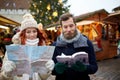 Happy couple with map and city guide in old town Royalty Free Stock Photo