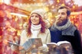 Happy couple with map and city guide in old town Royalty Free Stock Photo