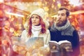 Happy couple with map and city guide in old town Royalty Free Stock Photo