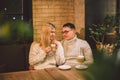 Happy Couple Meeting And Drinking Coffee. love and romantic date in downtown cafe restaurant. Young happy couple in love in cafe. Royalty Free Stock Photo