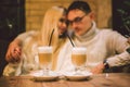 Happy Couple Meeting And Drinking Coffee. love and romantic date in downtown cafe restaurant. Young happy couple in love in cafe. Royalty Free Stock Photo