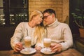 Happy Couple Meeting And Drinking Coffee. love and romantic date in downtown cafe restaurant. Young happy couple in love in cafe. Royalty Free Stock Photo