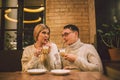 Happy Couple Meeting And Drinking Coffee. love and romantic date in downtown cafe restaurant. Young happy couple in love in cafe. Royalty Free Stock Photo
