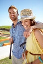 Happy couple, mini golf and hug on summer date, fun activity and freedom in sunshine. Man, woman and young people Royalty Free Stock Photo