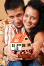 Happy couple with miniature house Royalty Free Stock Photo