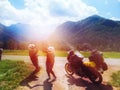 Happy couple of motorcyclists adventure bikers. Destination concept. Green meadow in Zgornje Jezersko, to Kamnik-Savinja Alps on a