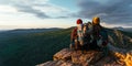 A happy couple in the mountains admires the beautiful views. A man and a woman with backpacks on the mountain admire the panoramic Royalty Free Stock Photo