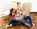 Happy couple moving together in a new house taking selfie video and pic