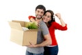 Happy couple moving together in a new house unpacking cardboard boxes Royalty Free Stock Photo