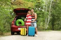 Happy couple near car trunk with suitcases Royalty Free Stock Photo