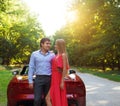 Happy couple near the red cabriolet Royalty Free Stock Photo