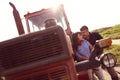 Happy couple near tractor on farm Royalty Free Stock Photo