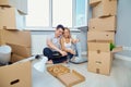 Happy couple in a new apartment for a housewarming.