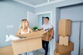 Happy couple in a new apartment for a housewarming. Royalty Free Stock Photo