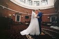 Happy couple of newlyweds hugging in luxury reception hall Royalty Free Stock Photo