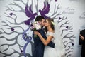 Happy couple of newlyweds kissing at wedding ceremony with illustated background Royalty Free Stock Photo