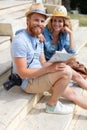 happy couple observing map and discussing their vacation Royalty Free Stock Photo