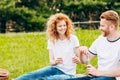 happy couple opening bottle of wine at picnic Royalty Free Stock Photo