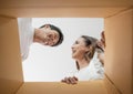 Happy couple opening a box and looking inside Royalty Free Stock Photo