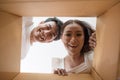 Happy couple opening a box and looking inside Royalty Free Stock Photo