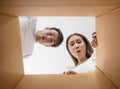 Happy couple opening a box and looking inside Royalty Free Stock Photo