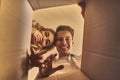 Happy couple opening the box after moving into new house Royalty Free Stock Photo