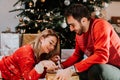 Happy couple opening a christmas present. Details of holidays Royalty Free Stock Photo