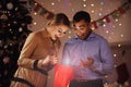 Happy Couple Opening Christmas Present Royalty Free Stock Photo